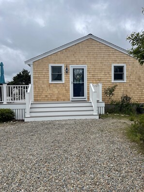 Cottage with new siding and deck