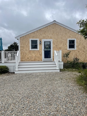 Cottage with new siding and deck