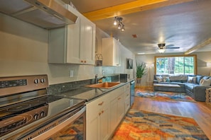 The open kitchen has gorgeous granite counters and stainless steel appliances 
