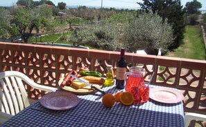 Enjoy eating on the terrace acrosss the garden towards the sea in the distance