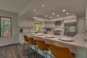 Kitchen area with stainless-steel appliances, and spacious island