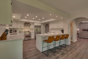 Kitchen area with stainless-steel appliances, and spacious island