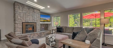 Living area with contemporary furniture, flat screen tv, and fireplace