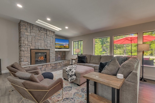 Living area with contemporary furniture, flat screen tv, and fireplace