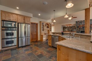 Kitchen area with stainless steel appliances and large island