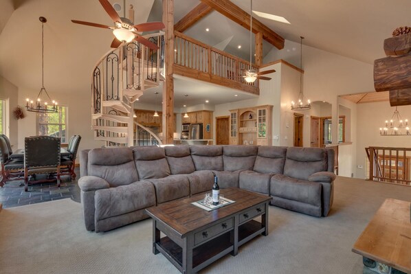 Living area with large sofa and spiral staircase