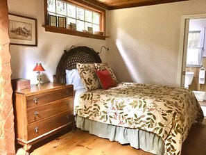 bedroom with queen bed and bath with large shower and sink with vanity