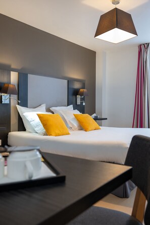 Close-up details showcase the inviting atmosphere, highlighting the combination of plush bedding, practical amenities, and tasteful decor that frames a tranquil retreat for travelers.
