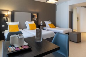 Bathed in natural light, this inviting space features a harmonious blend of single and double beds.