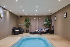 Relaxing shared spa zone with a small pool and steam room, accessible on-site at the residence.