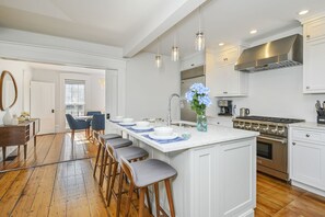 Large center Island with seating for 4 , entrance to the dining room.