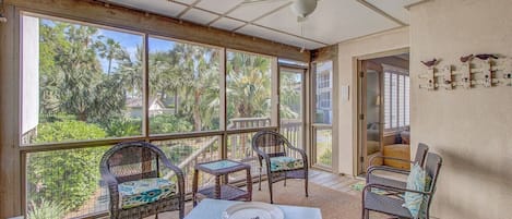 Screened porch with seating.