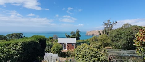 Kohanga sits at the bottom of the garden with Banks Peninsula  in the background