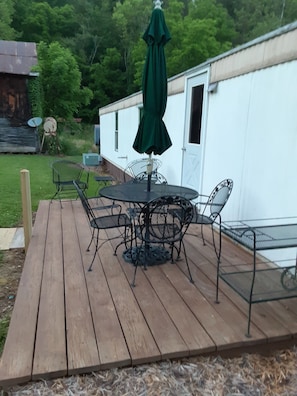 Back porch/ patio area with outdoor dining.