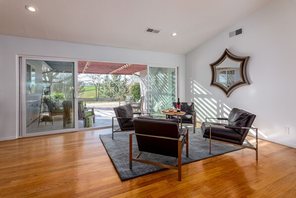 Sitting area with large sliding doors leading to the covered lounge