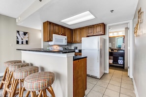 Enjoy a breathtaking backdrop for cooking in our suite's kitchen, where each meal preparation is accompanied by the ever-changing beauty of the ocean just outside the window.