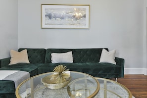 Elegant living room. Green couch folds down into a Full sized bed.