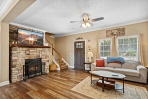 Mounted Big Screen TV above the Stacked Stone Fireplace