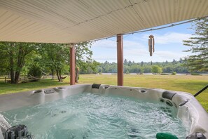 Relax and unwind in the hot tub with a breathtaking lake view.