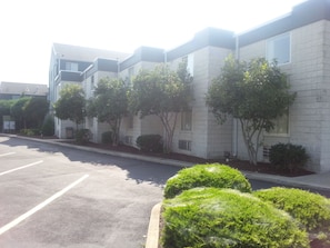 Side of the building where there is a lot of parking available.