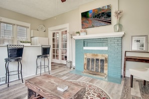 Beautiful open-concept living area with original  (not functional) fireplace.