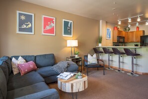 The open layout from the living room to the kitchen allows for everyone to come together