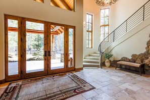 Large entrance with grand staircase and chandelier.