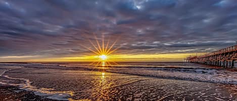 Welcome to our happy place where there is a beautiful sky above, soft, sand below, and oh, we are located right across the street from the ocean.  Most of our  reviews speak of our amazing proximity to the beach.