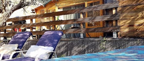 Cabana, decked area, day bed & chairs under shaded olive tree