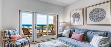 Living room with a view of the ocean and pool