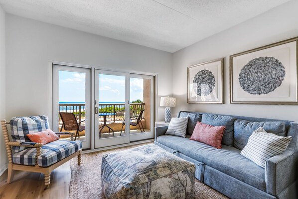 Living room with a view of the ocean and pool