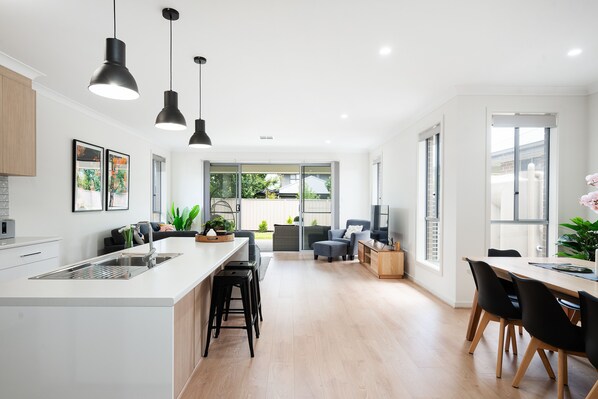 Spacious open-plan living/dining area with 8 chairs. Modern kitchen for culinary delights.