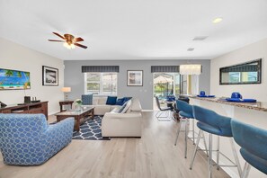 Family room, fully equipped kitchen and dining area, views to pool, 