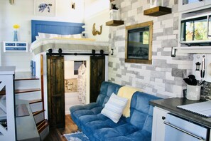 Air conditioning and heat with fireplace above sofa.  Barndoor closet space.