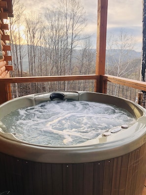 Soak in the hot tub while you take in the mountain views.
