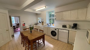 Kitchen with washer, dryer, dishwasher, microwave, coffee machine fridge freezer