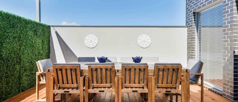 Outdoor area with large dining table and party lights