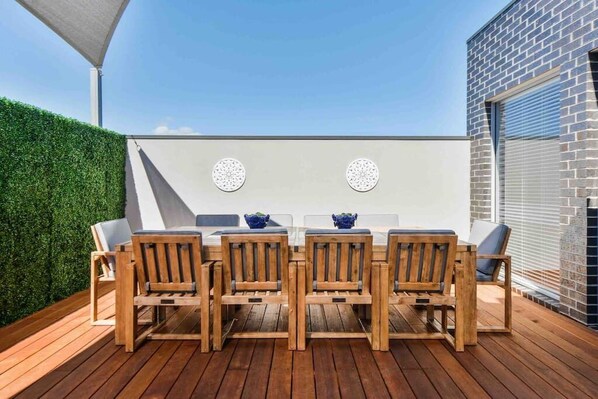 Outdoor area with large dining table and party lights