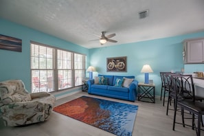 Living room with recliner, sleeper sofa, TV with cable + roku.