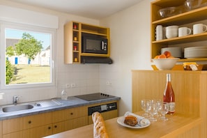 Prepare meals in the kitchenette and enjoy them at the dining table.