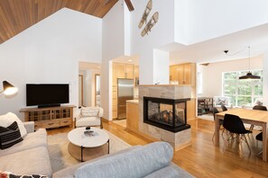 Living area features a TV and stylish gas fireplace