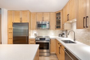 Contemporary kitchen with granite worktops and stainless steel appliances