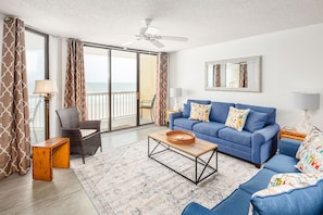 Cozy living room with ocean views and private balcony