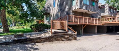 Front unit with windows on 3 sides and 2 car carport directly underneath unit.