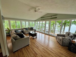 Living room with gorgeous lake views overlooking the spacious deck