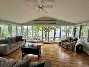 Living room with gorgeous lake views overlooking the spacious deck