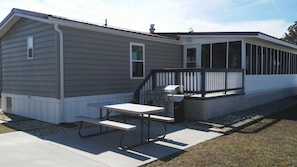 Sun deck/ Patio area with large gas grill and picnic table.
