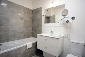Get ready for your day in the bathroom, which features either a bathtub or a shower.