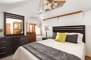 Comfy queen bed in the master bedroom, large dresser, reading lamp, ceiling fan, natural light... perfect oasis for recharging.