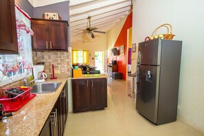 Fully equipped kitchen with stove and microwave